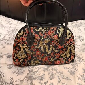 Vintage Chicos Elegant Black and Gold Handbag with Red Accents